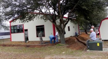 Digging trenches for utilities next door begins.
