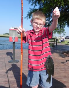 Our youngest grandson poses with his first fish!
