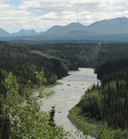 A view of the river with mountains behind. 