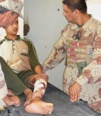 Two Iraqi medics treat a burn patient.