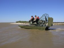 A biologist and volunteers head out to the rookery island on the airboat.